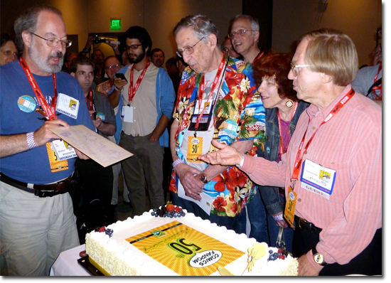 Mike Tuohey presents Roy Thomas with an original Alter Ego #1!